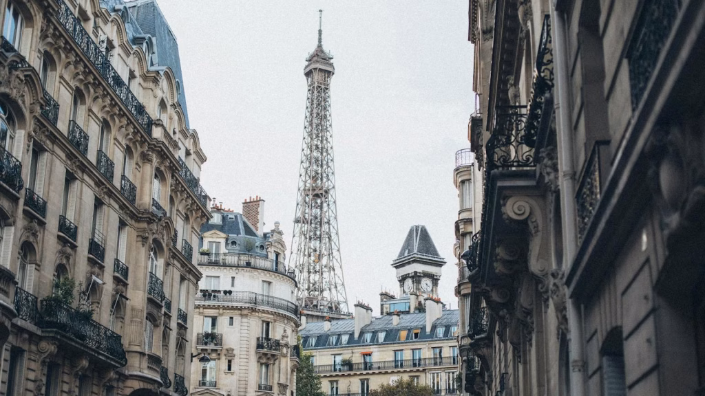 Scenic view of the Eiffel Tower framed by classic Parisian architecture on a charming street.