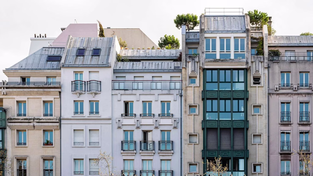 A picturesque view of a classic Parisian building facade with balconies and windows.