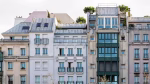 A picturesque view of a classic Parisian building facade with balconies and windows.